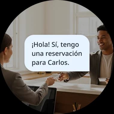 Two people having a conversation, with a speech bubble showing the Spanish phrase '¡Hola! Sí, tengo una reservación para Carlos,' illustrating a real-life dialogue mission